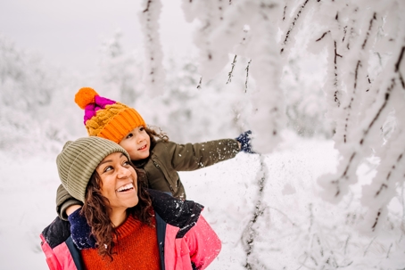 mother and daughter playing in the snow