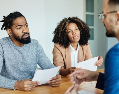 couple reviewing documents with an attorney