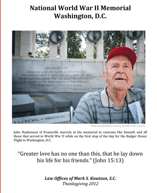 Elderly man in red cap at National World War II Memorial with engraved stone wall background.